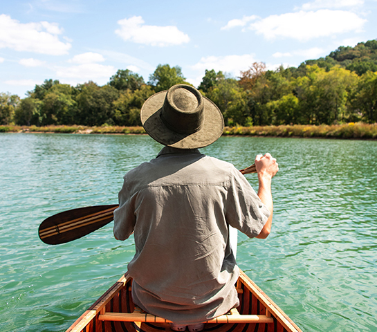 a man in a boat on a lake