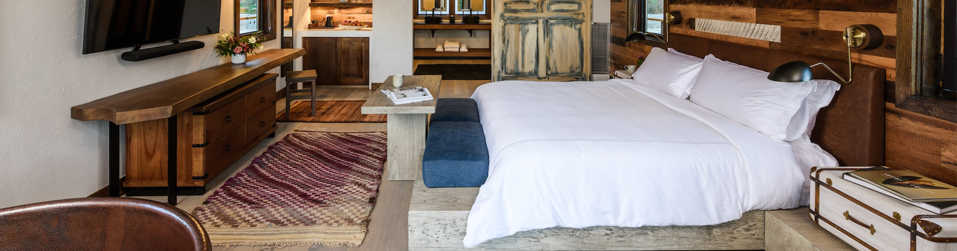 a bed with a table and rug