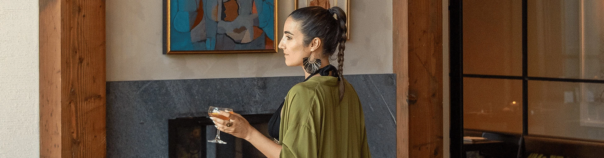 a woman holding a drink