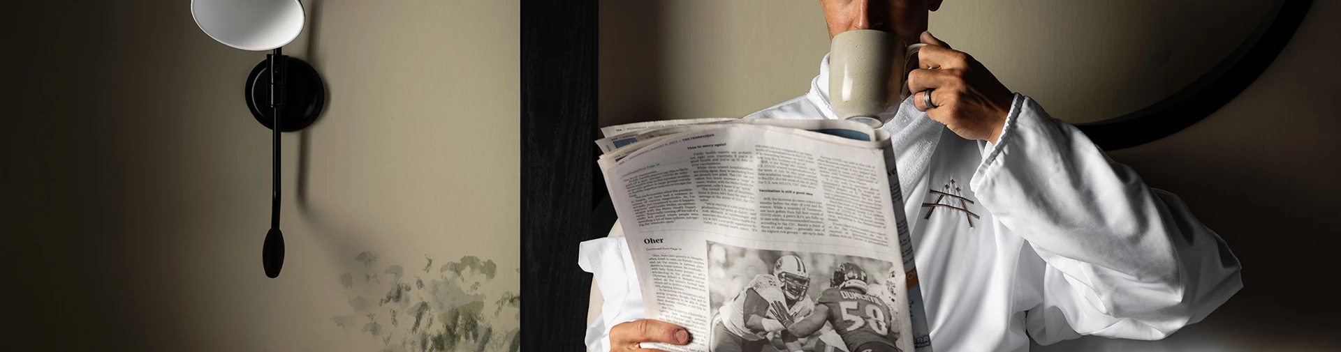 a man holding a newspaper