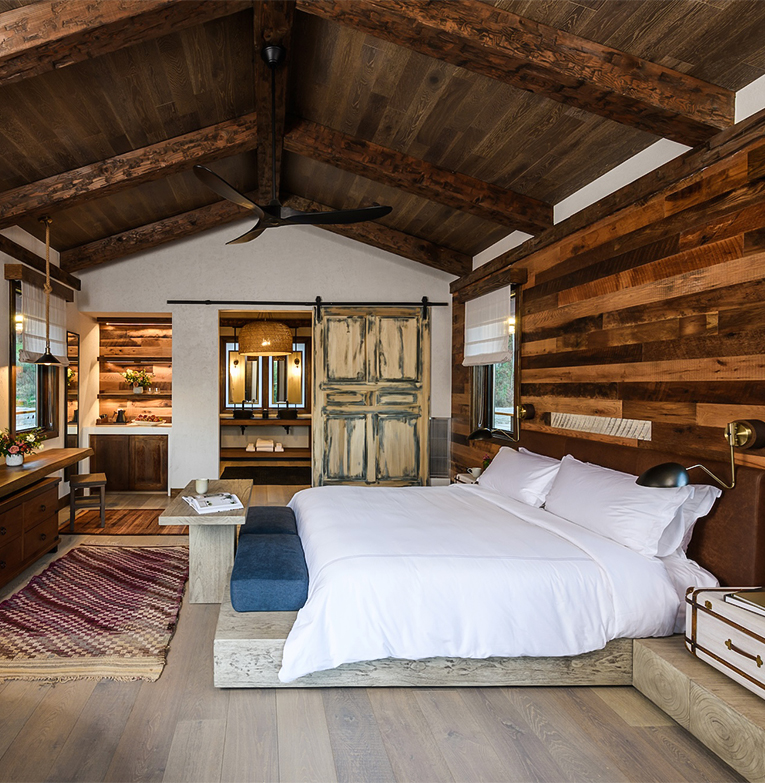 a bedroom with wood walls and a large bed