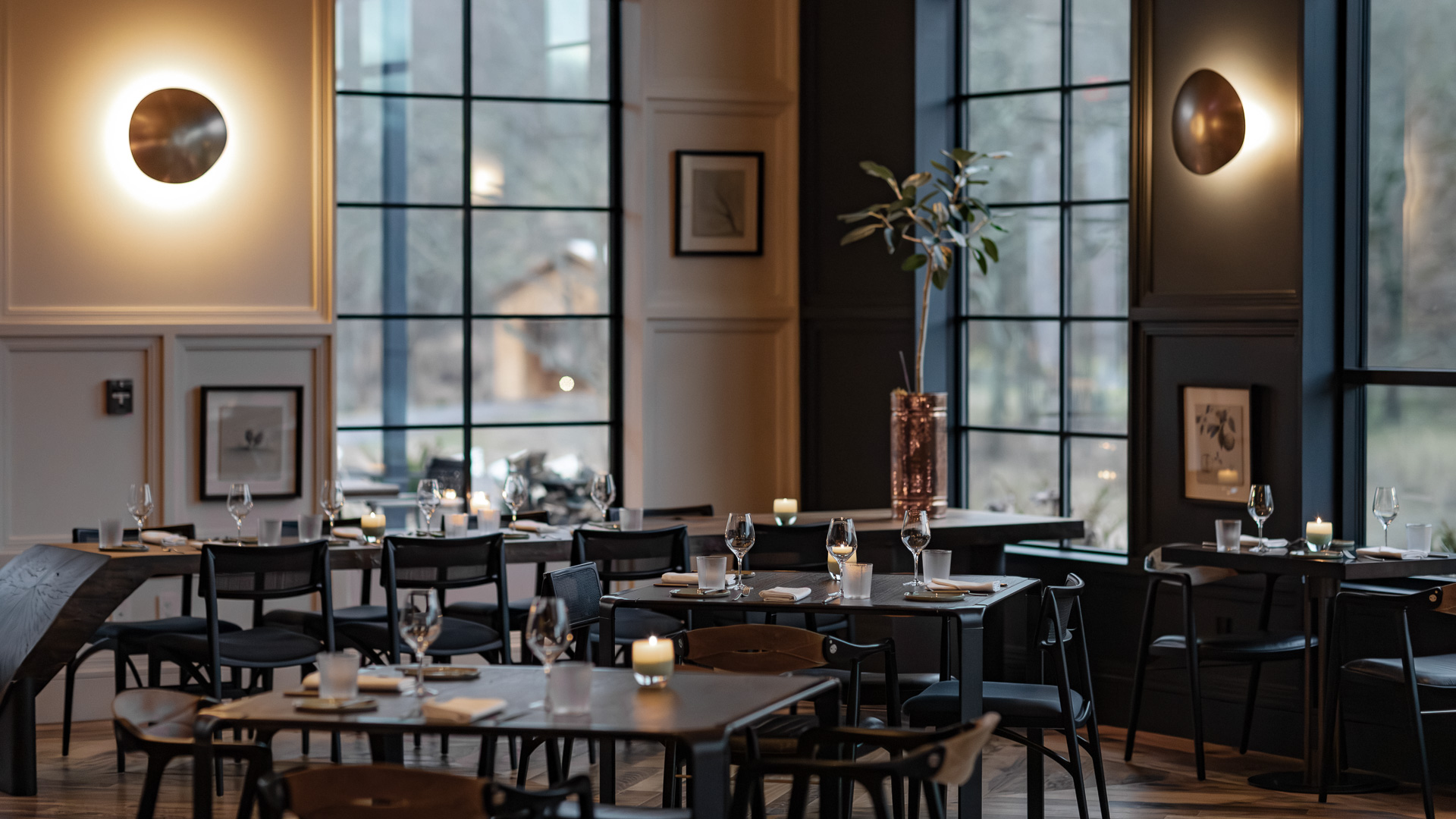 a room with tables and chairs and candles