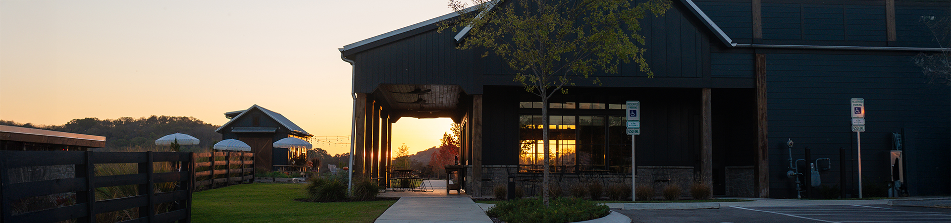 a building with a porch and a tree