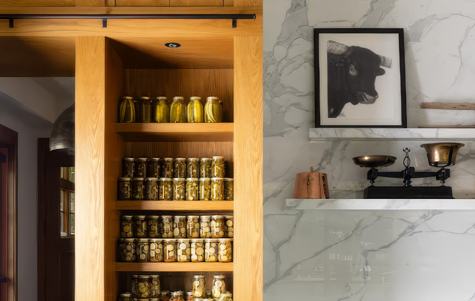 a shelf with jars of pickles and a painting on the wall