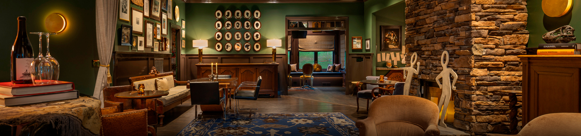 a room with a green wall and a table and chairs