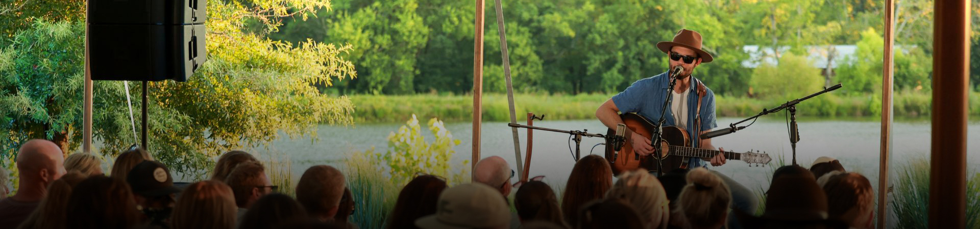a group of people watching a man play a bow