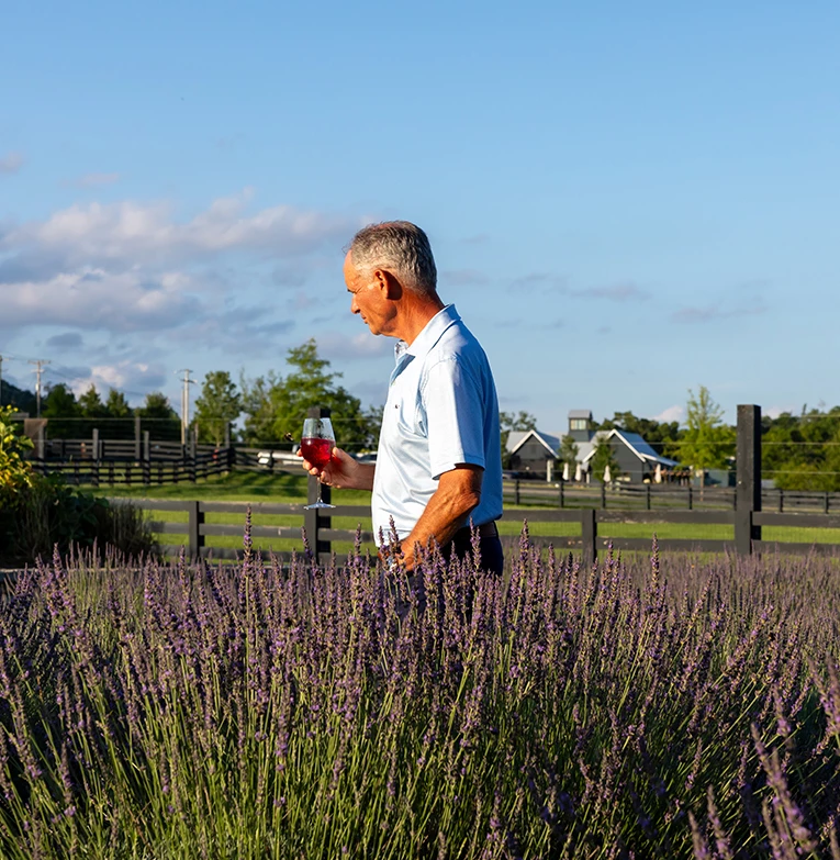 a man standing in a field of lavender