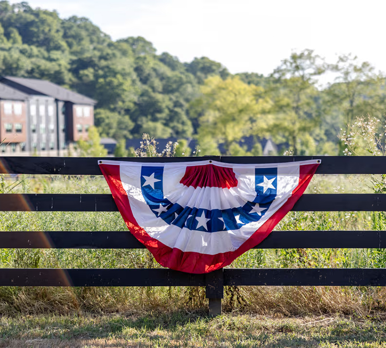 a red white and blue banner on a fence