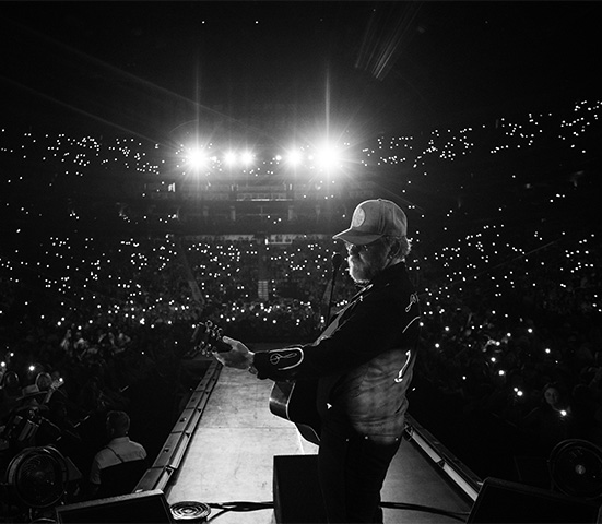 a man playing a guitar on a stage