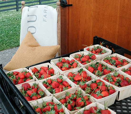a group of strawberries in baskets