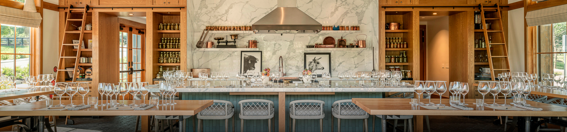 a kitchen with a marble countertop and chairs