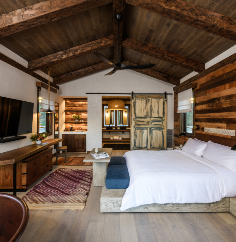 a bedroom with a large bed and a television