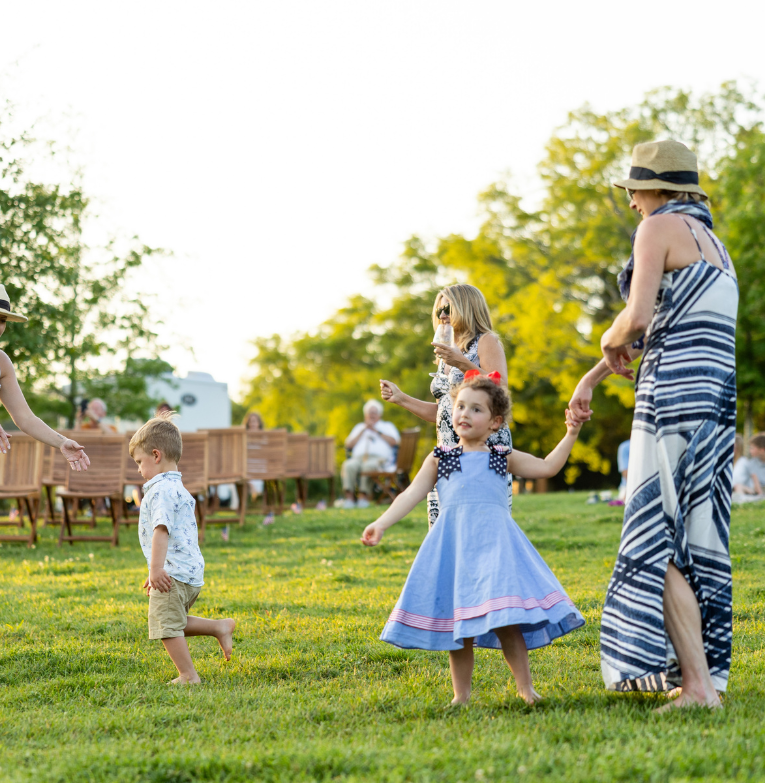 a group of people walking on grass