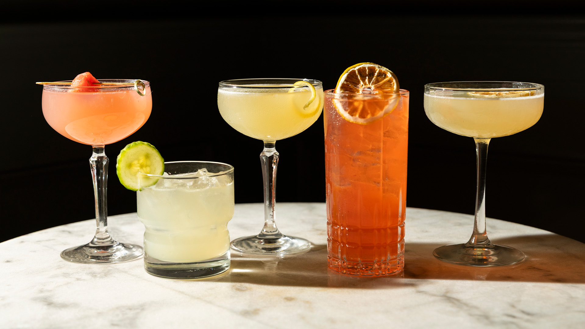 a group of different colored drinks on a table