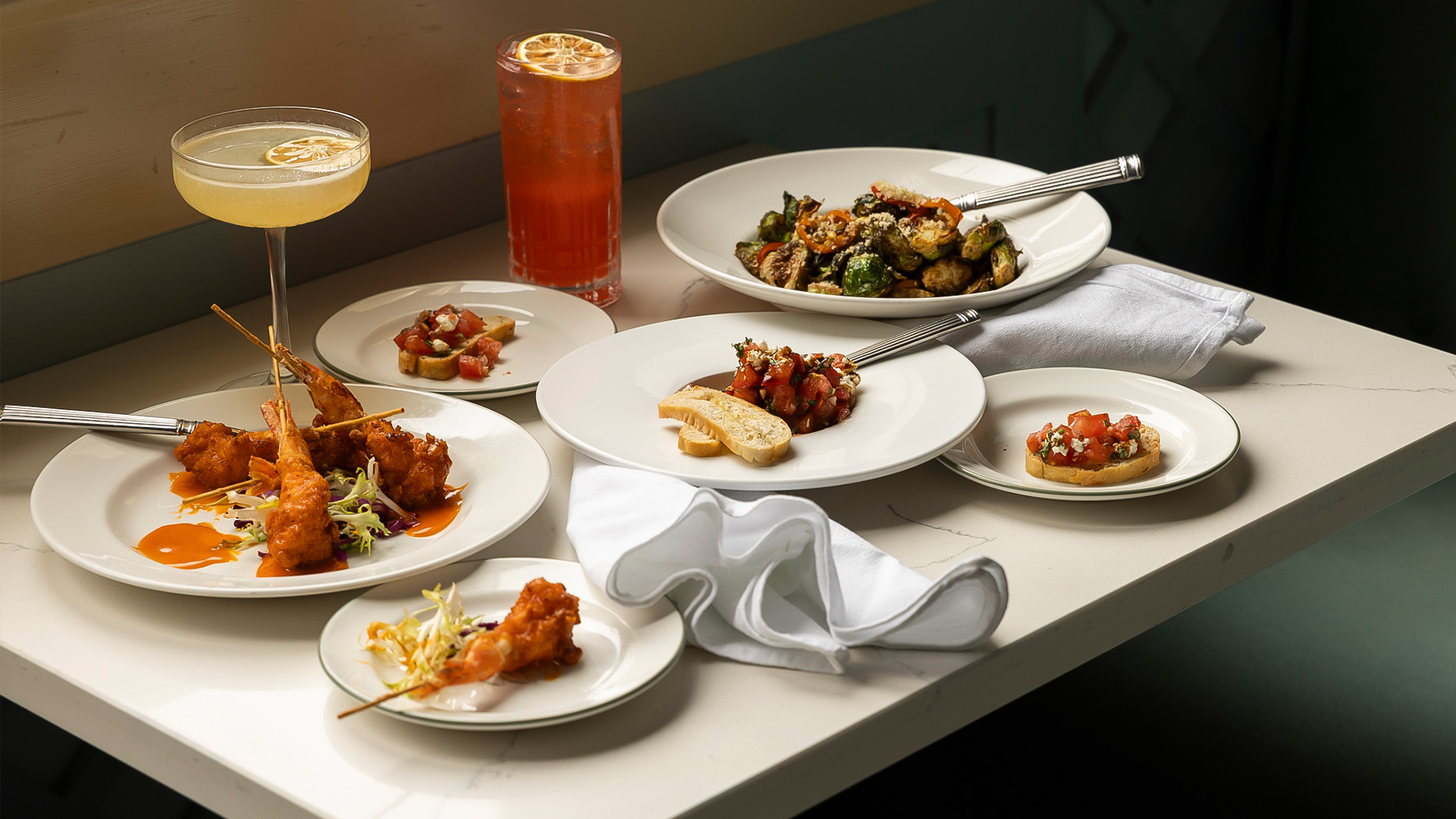 a table with plates of food and drinks