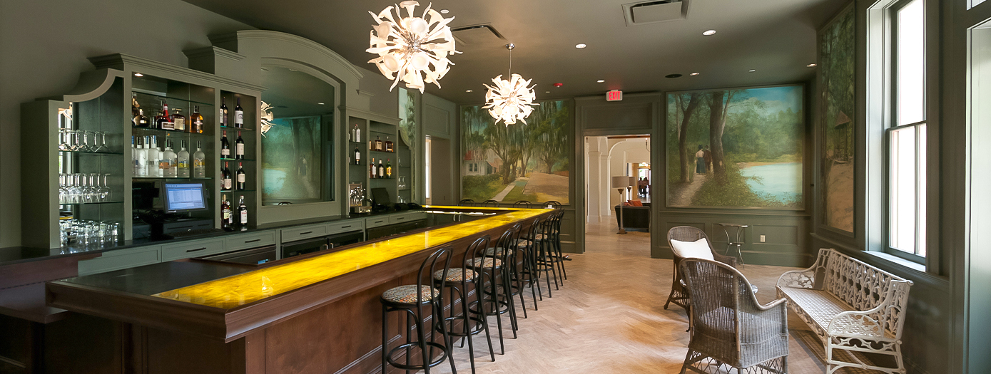 a bar with chairs and a yellow bar