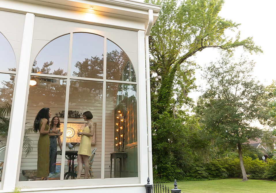 a group of women standing in front of a building