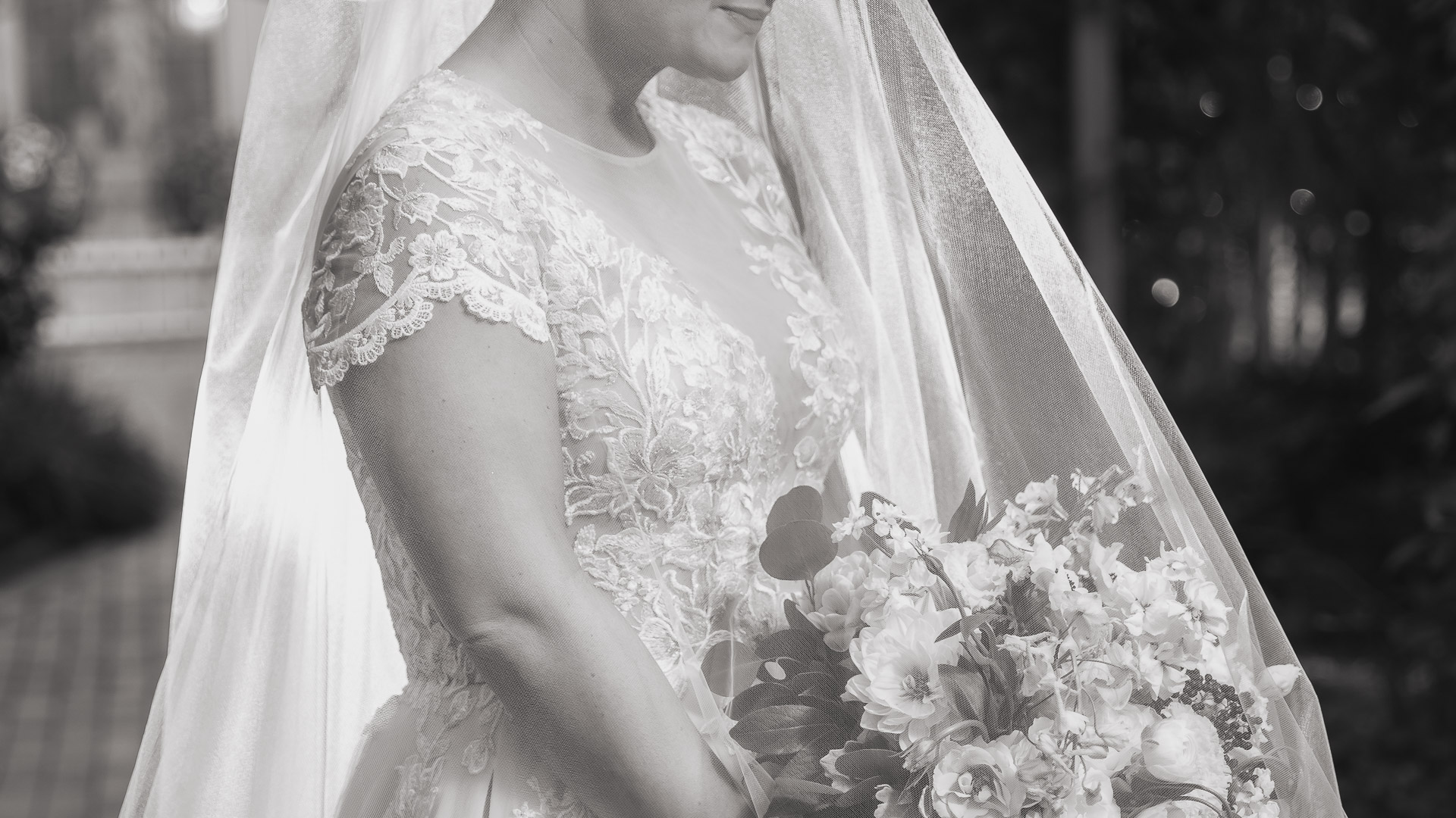 a woman in a wedding dress holding a bouquet of flowers