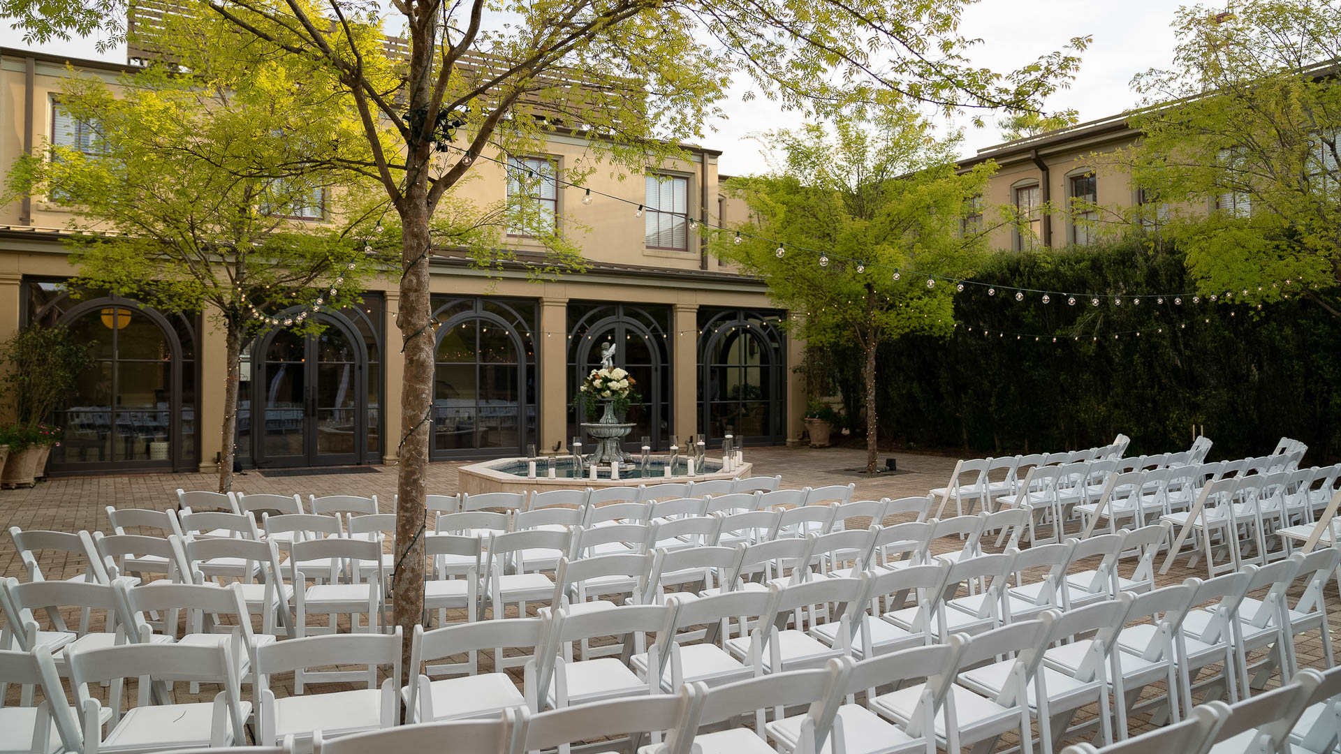 a group of white chairs in a courtyard