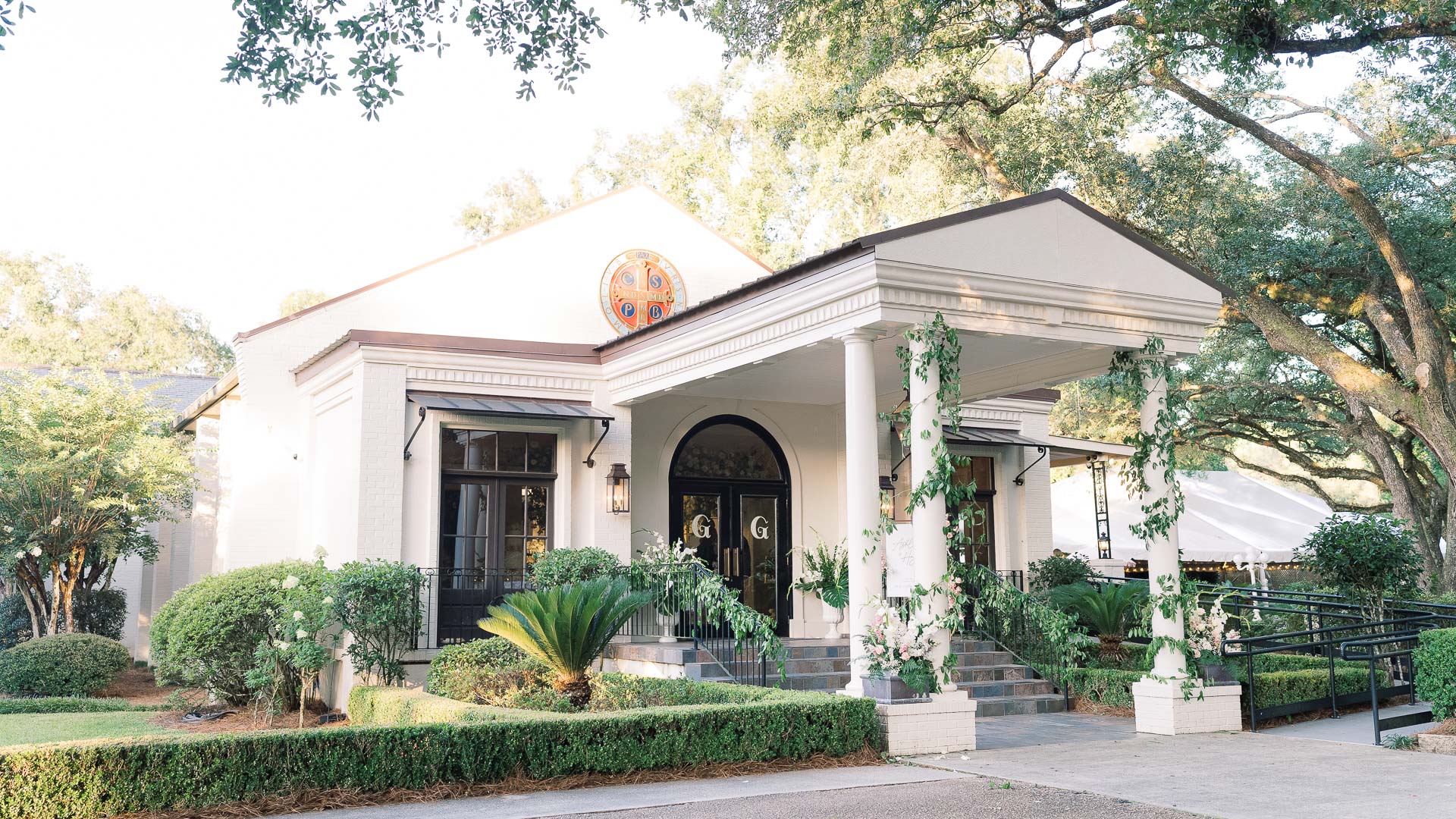 a white building with columns and a door