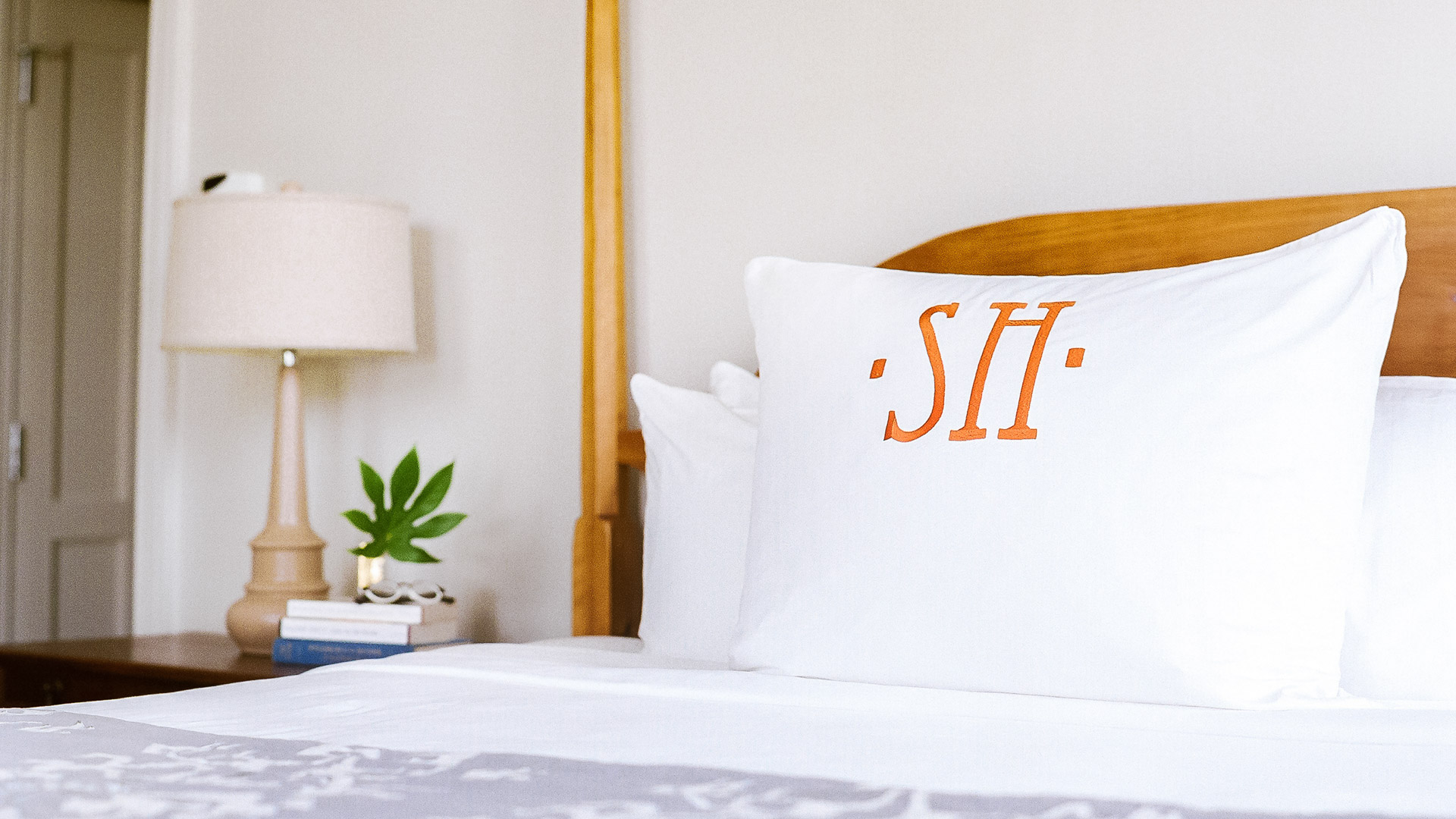 a white pillow with orange letters on it