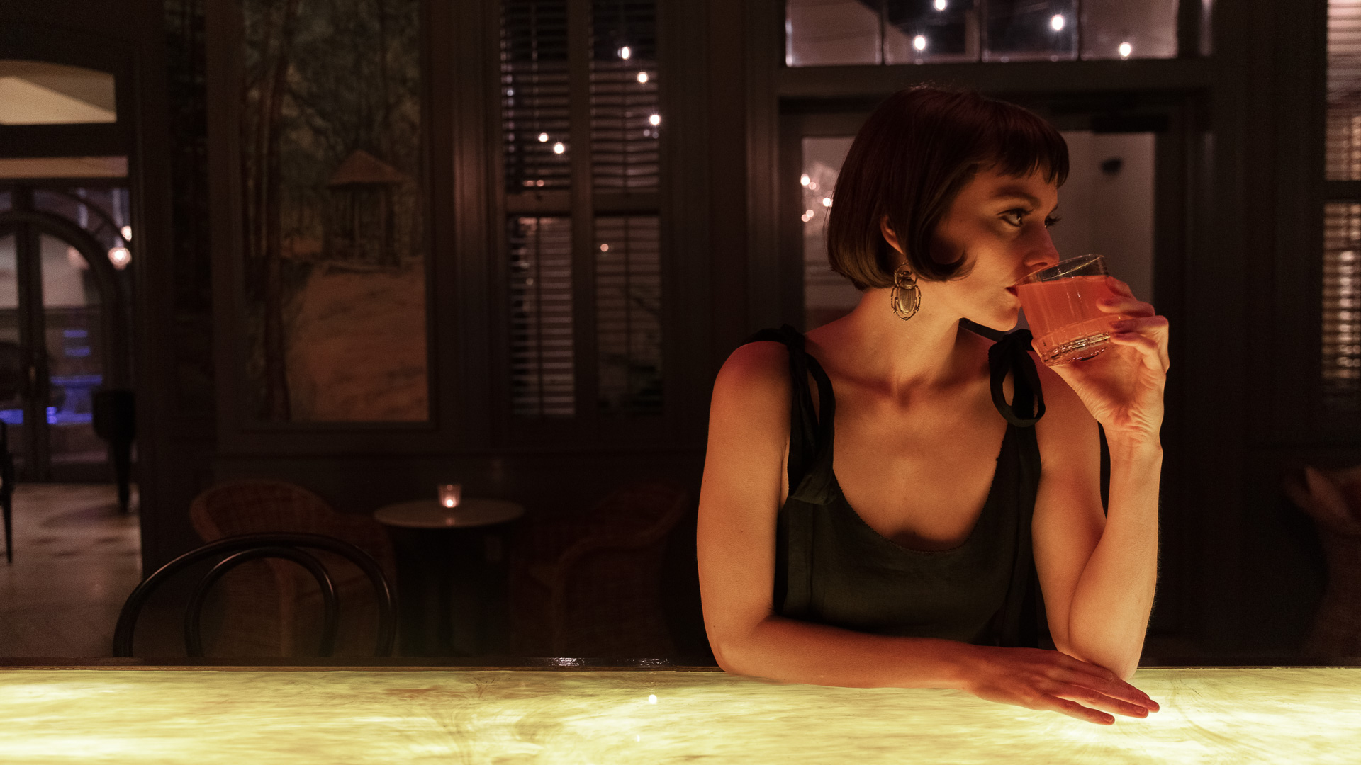 a woman drinking from a glass