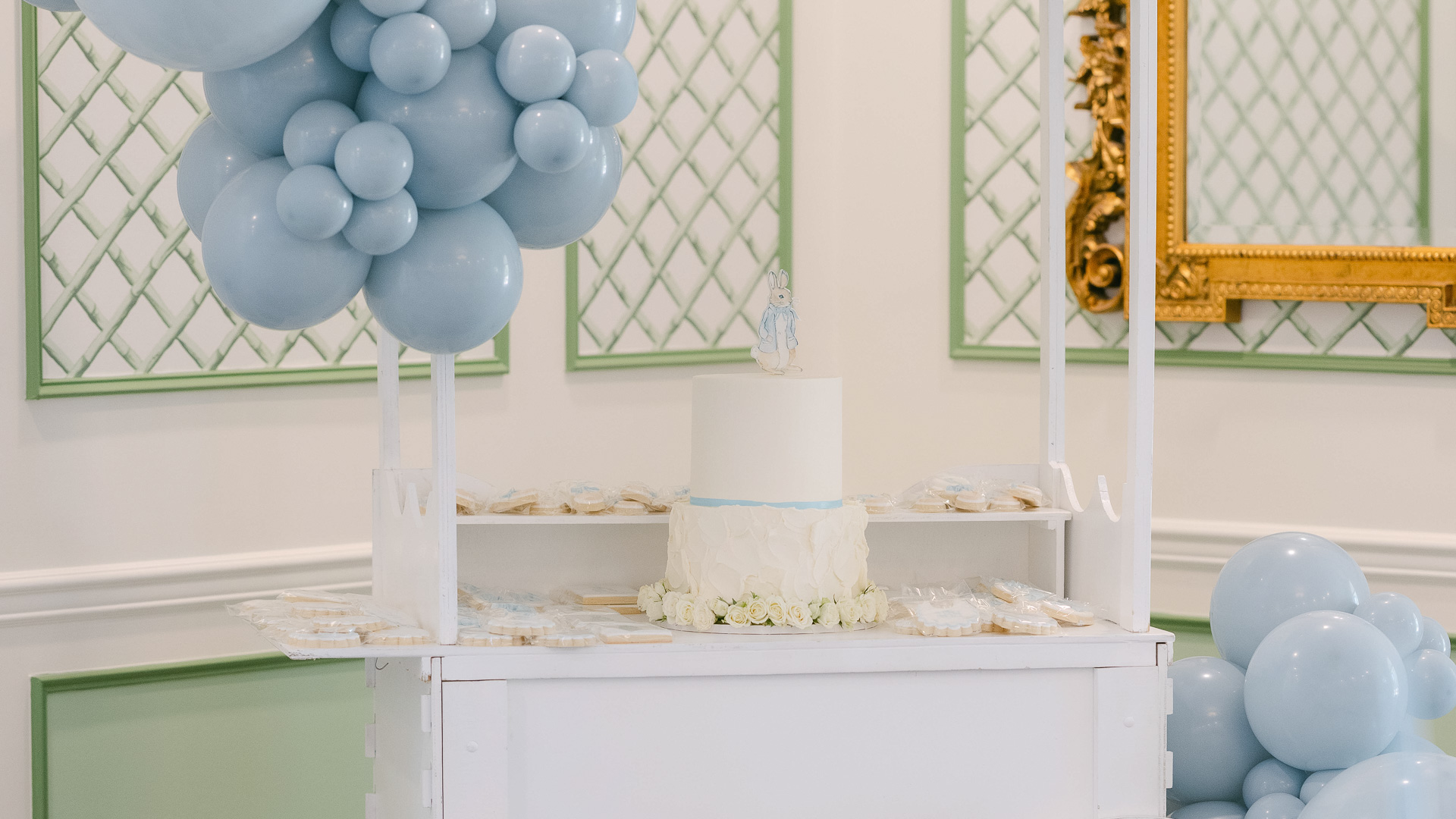 a cake and balloons on a table