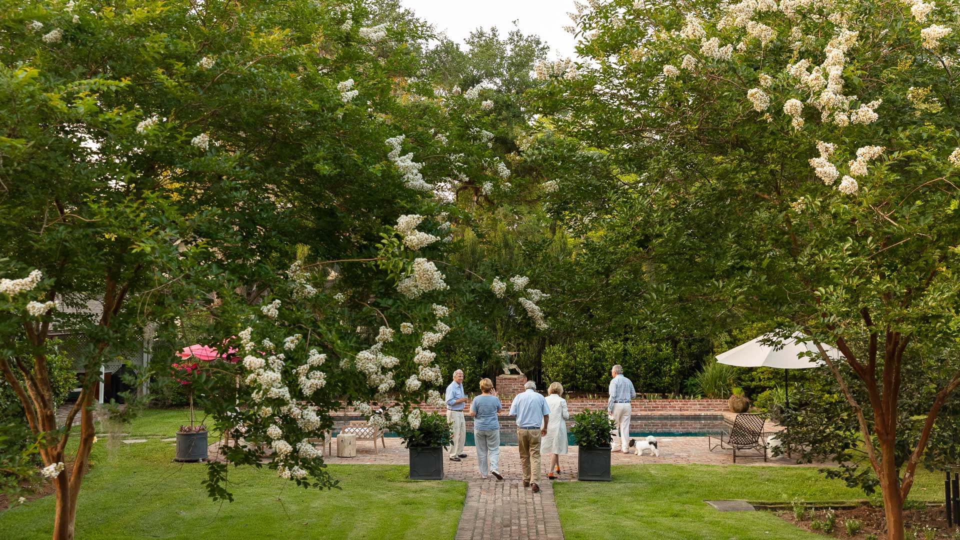 a group of people walking on a brick path