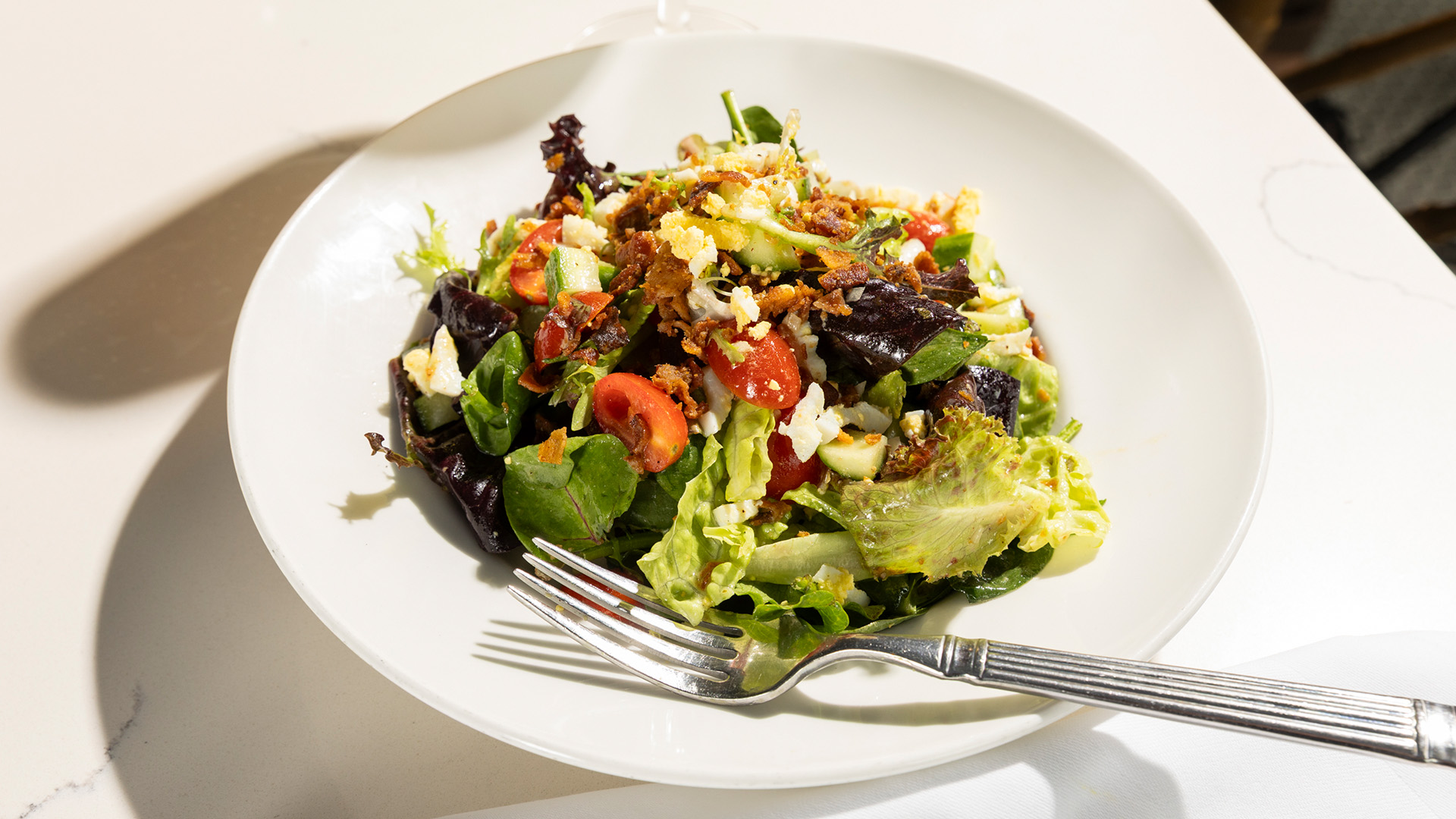 a plate of salad with fork