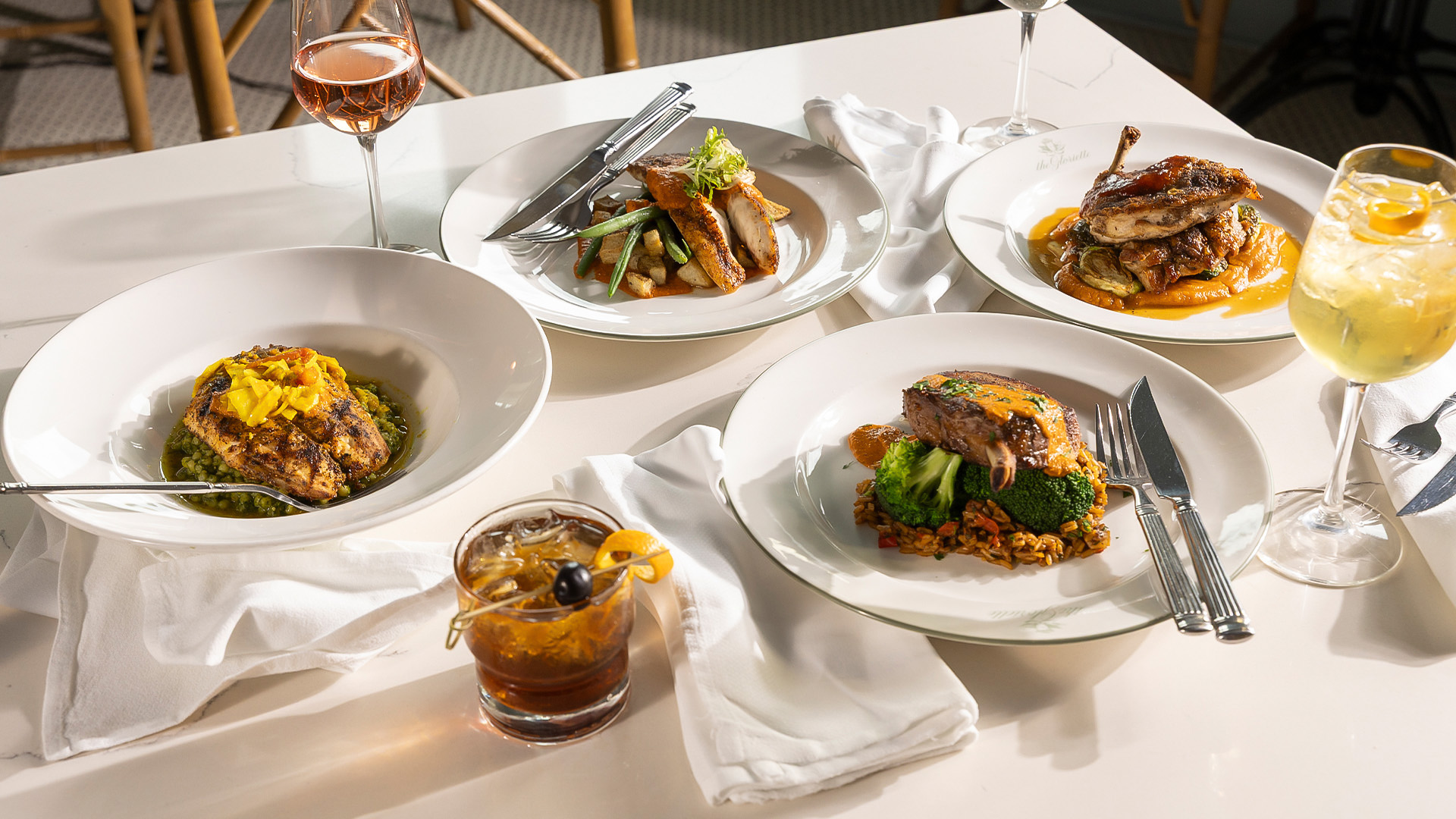 a table with plates of food and drinks