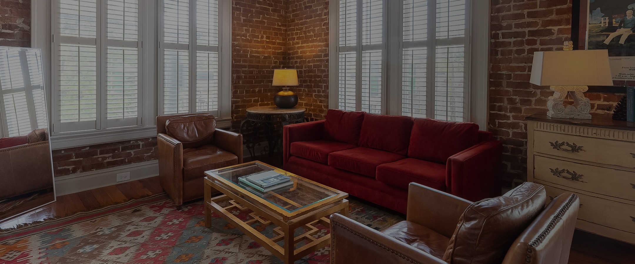 a living room with red couches and a coffee table
