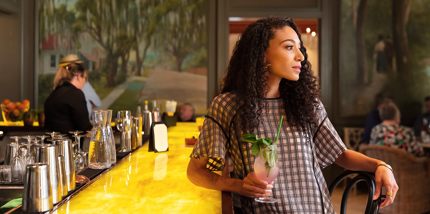 a woman holding a drink