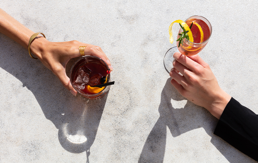 a man and woman holding drinks