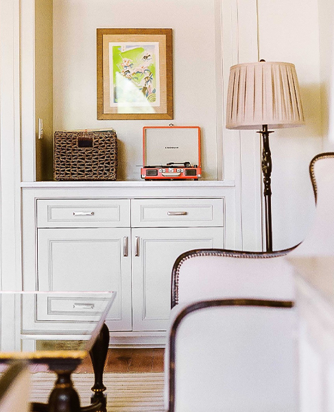 a room with a table and chairs and a record player