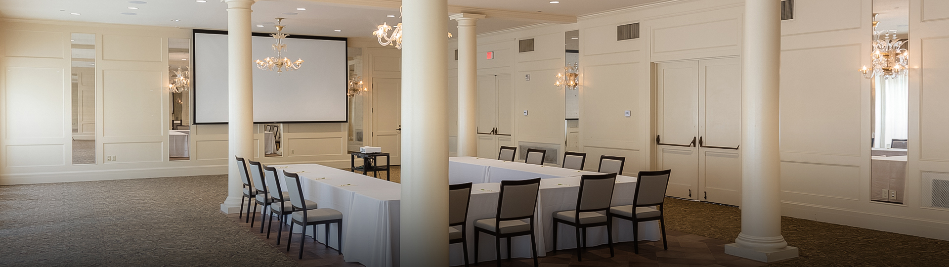 a room with white tables and chairs