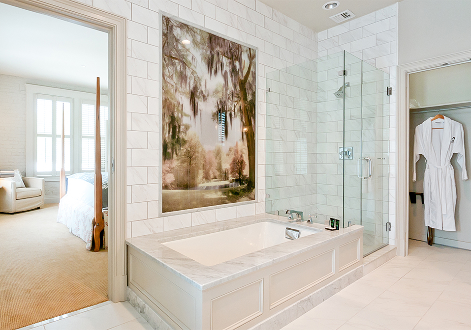 a bathroom with a large tub and glass shower