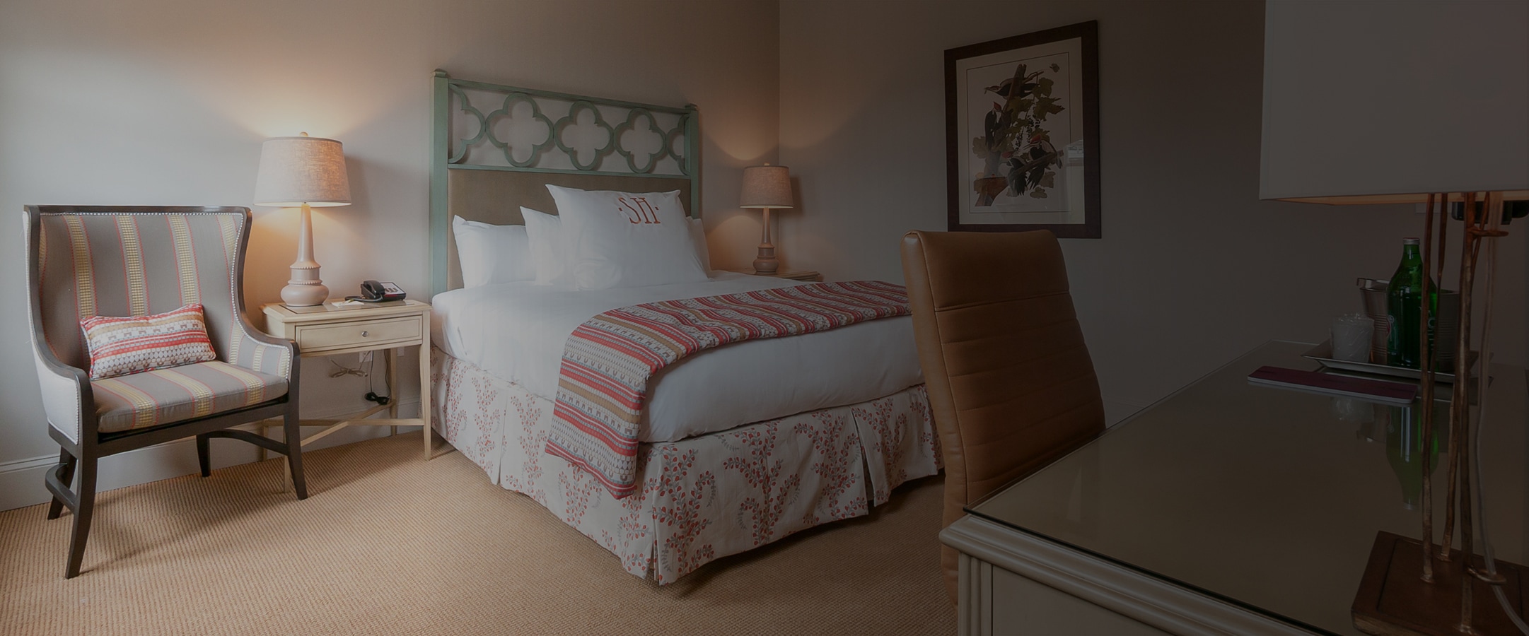 a bed with a lamp and a desk