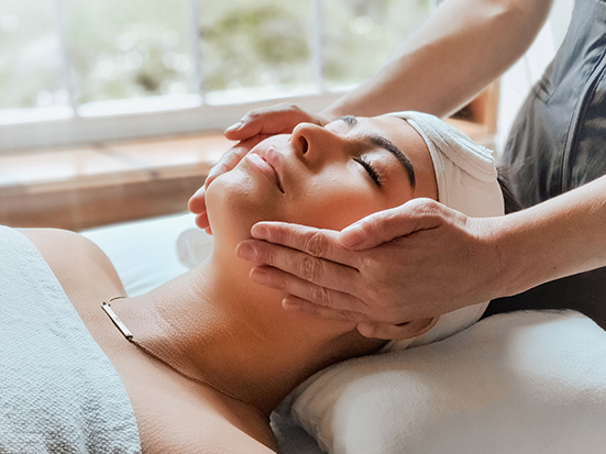 a woman receiving a face massage