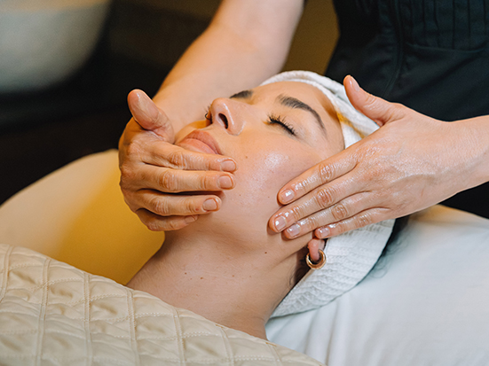 a woman receiving a face massage