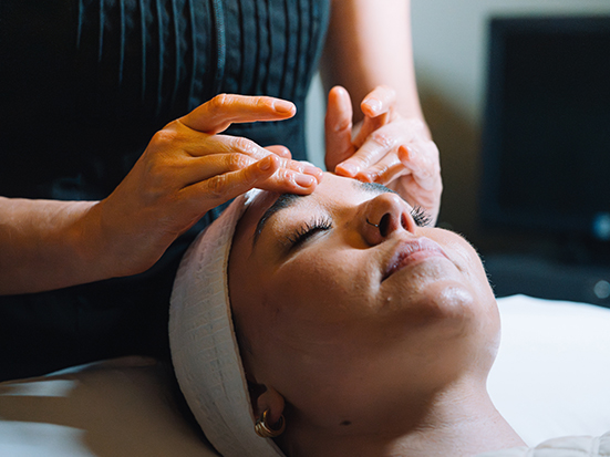 a woman receiving a face massage