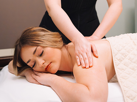 a woman lying down on a massage table