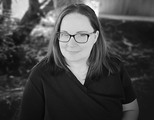 a woman wearing glasses and a black shirt