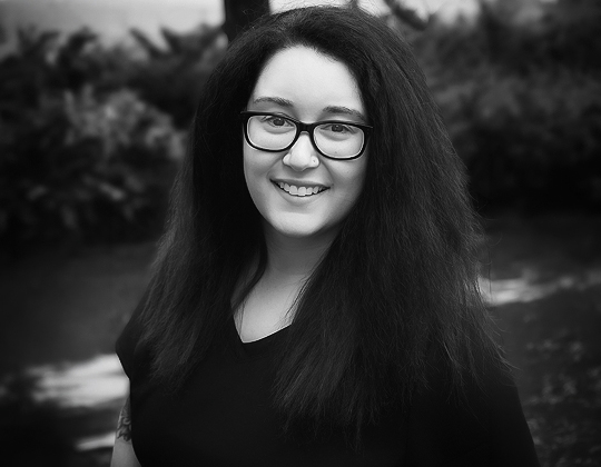 a woman with long hair wearing glasses