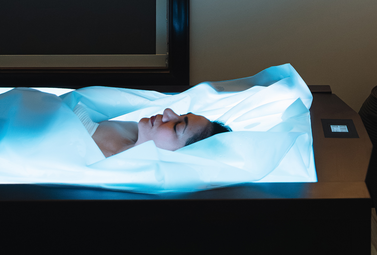a woman lying in a white sheet