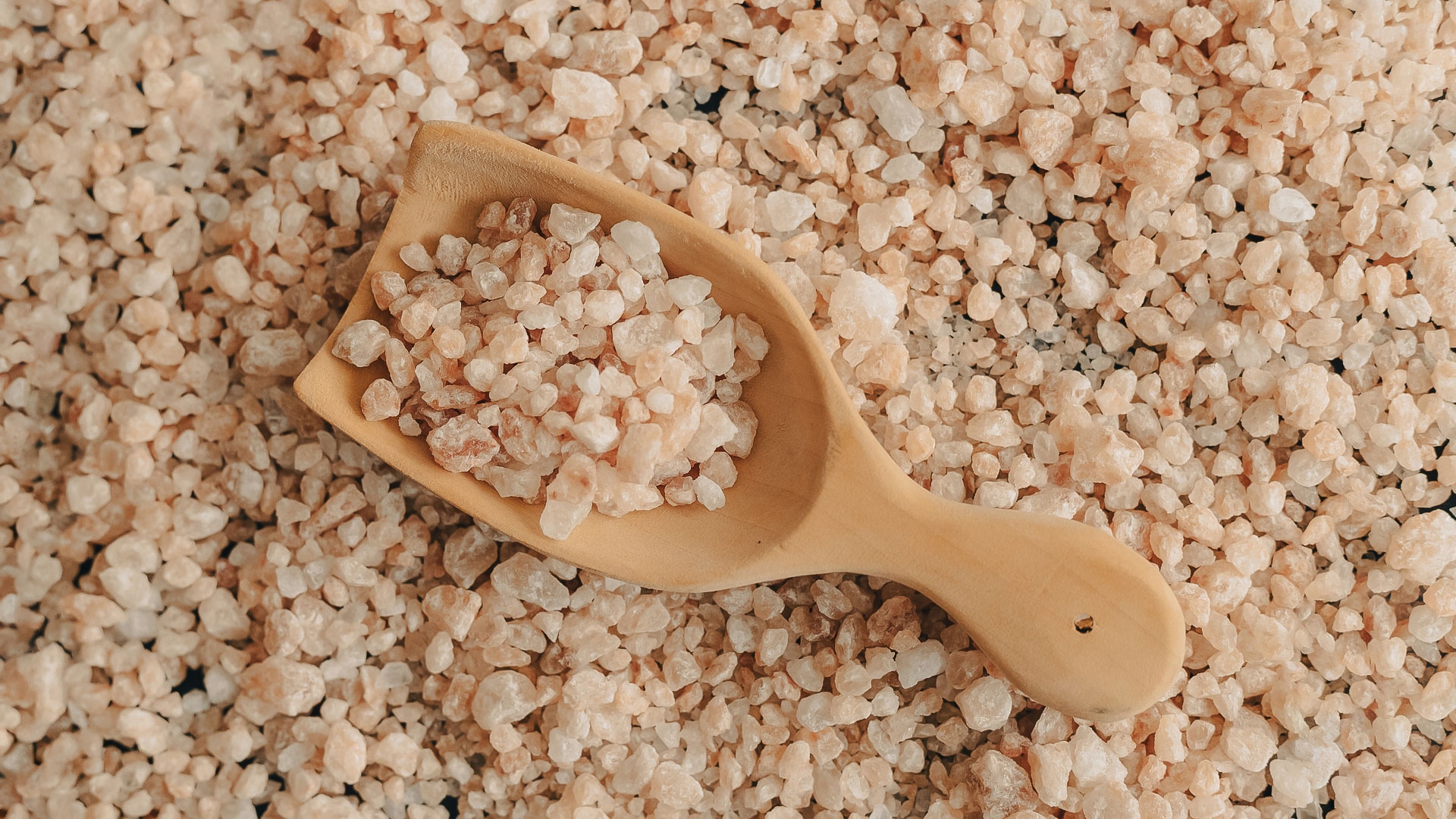 a wooden spoon with small rocks