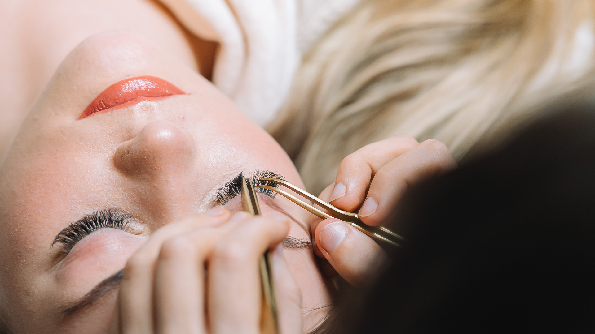 a woman getting eyelash extensions done