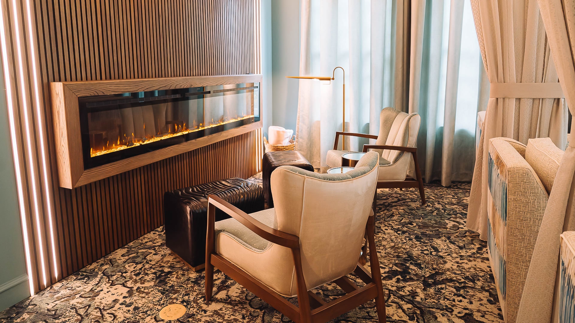 a room with a fireplace and chairs