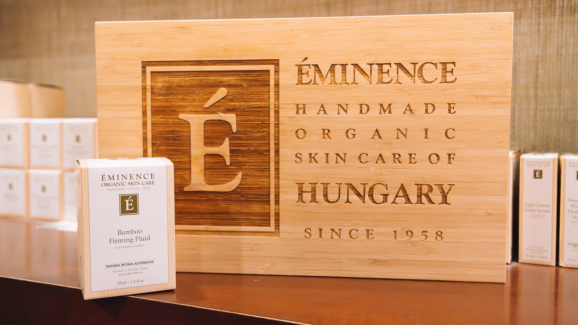 a wooden sign with a white box and a white box on a table