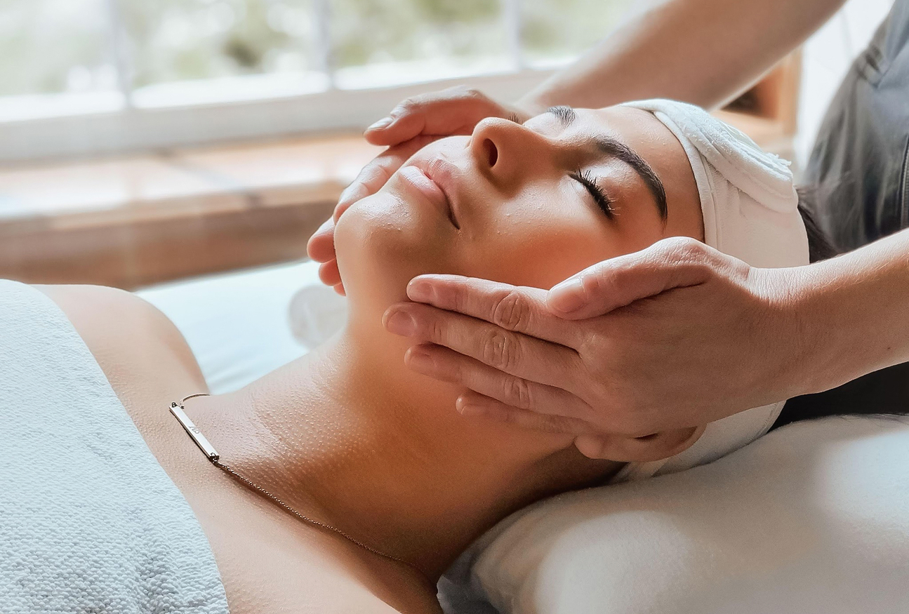a woman receiving a face massage
