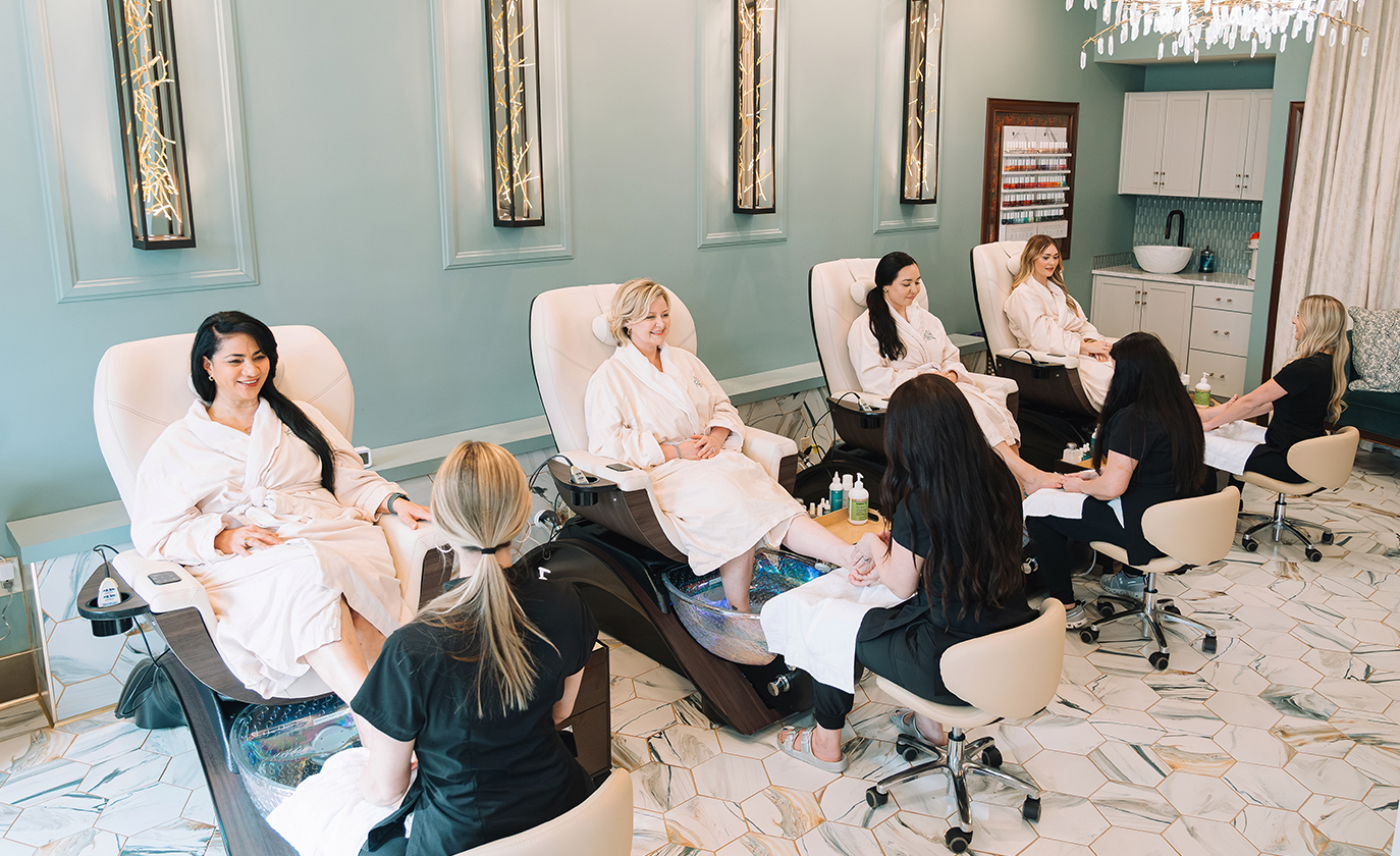 a group of women in white robes sitting in chairs